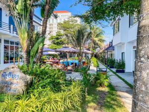 a resort with a pool and palm trees at Sea Breeze Resort in Sihanoukville