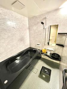 a bathroom with a black tub and a sink at Villa Inuyama - Vacation STAY 87603v in Inuyama