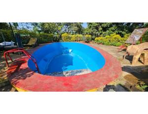 a small swimming pool with a fire pit in a yard at Eve Resort, Pachmarhi in Pachmarhī