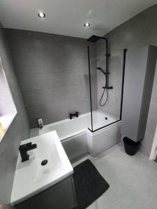 a bathroom with a shower and a sink and a tub at Luxury 3 bed coastal house in North Tyneside