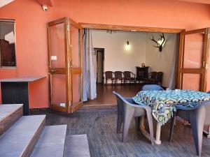 a living room with a table and a dining room at Nivritti Villa 2BHK Private Villa in Matheran Full Privacy & Prime Location in Matheran in Matheran