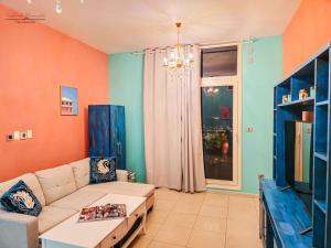 a living room with a couch and a table at Waterfront Tropical Themed 2 BR in Abu Dhabi