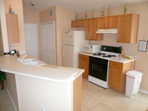 a kitchen with a sink and a stove top oven at Five-Bedroom Pool Home Davenport in Davenport