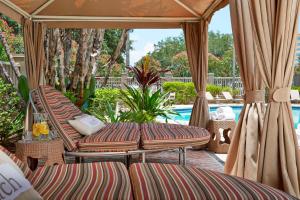 a patio with two lounge chairs and a pool at Renaissance Orlando Airport Hotel in Orlando