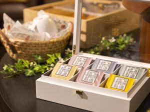a box of chocolates on a table with a basket at Kobe Tor Road Hotel Sanraku in Kobe
