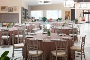 a large banquet hall with tables and chairs at Renaissance Orlando Airport Hotel in Orlando