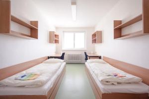 Postel nebo postele na pokoji v ubytování Koleje J.A.Komenského