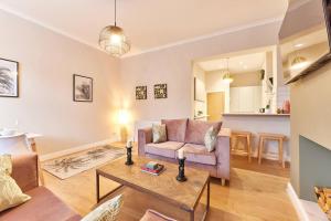 un soggiorno con divano e tavolo di Modern Luxury 2-bedroom Oasis In Heart Of Whitley a Whitley Bay