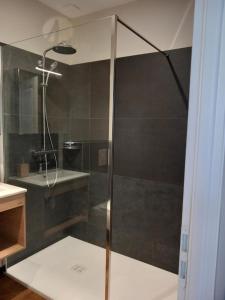 a shower with a glass door in a bathroom at Room in Guest room - Decouvrez un sejour relaxant a Meursault, en France in Meursault