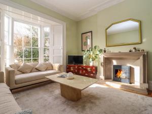 a living room with a couch and a fireplace at Mount Lebanon in Clevedon