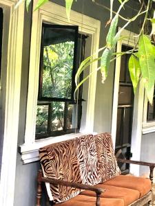 a zebra print couch sitting in front of a window at Tanzania Homestay in Arusha