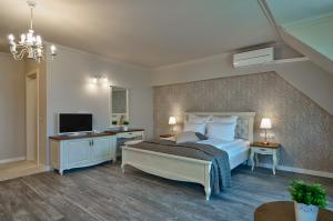 a bedroom with a bed and a television in it at Sunny Castle Hotel - All Inclusive and Free parking in Kranevo