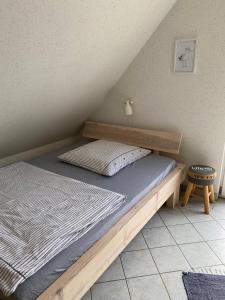 a bed with a wooden frame in a room at Ferienhaus Steilküste in Fehmarn