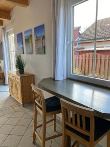 a dining room with a table and two chairs at Ferienhaus Steilküste in Fehmarn