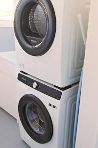 a dryer and a washing machine in a room at Bayview Oasis- With pool in Hardys Bay