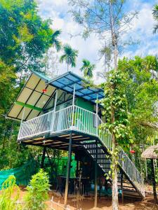 a tree house in the middle of a playground at River zone villa in Meppādi