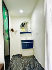 a bathroom with a sink and a mirror at River zone villa in Meppādi