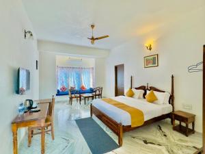 Jag Aravali Resort Udaipur- Experience Nature away from city Hustle في أودايبور: غرفة نوم مع سرير مزدوج كبير ومكتب