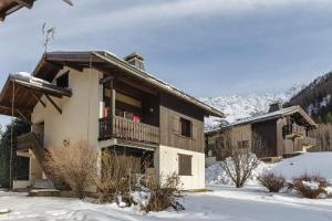 a building with a balcony in the snow at Hameau Des Grands Montets - Apartment 127 - Happy Rentals in Chamonix