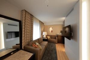 a living room with a couch and a television at Solaria Nishitetsu Hotel Seoul Myeongdong in Seoul