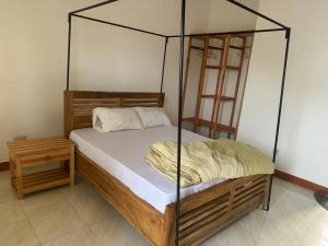 een slaapkamer met een hemelbed en een tafel bij Seven Seven B&B in Arusha