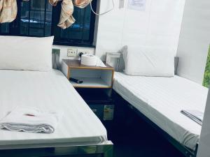Ένα ή περισσότερα κρεβάτια σε δωμάτιο στο New Cosmos Hotel