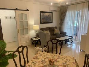 a living room with a couch and a table at vistas desde montequinto in Dos Hermanas