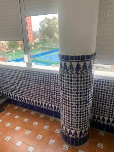 a bathroom with a blue and white shower curtain at vistas desde montequinto in Dos Hermanas