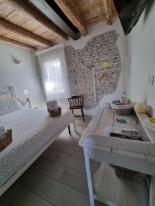 a bedroom with a bed and a table in a room at La Corte di Rosa in San Vito al Tagliamento
