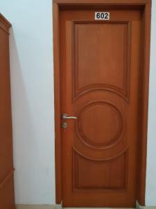 a wooden door with a sign on it at Villa Mawar Bumi Citeko in Bogor