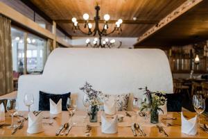 a table set up for a wedding with a white chair at Das Naturhotel die Eng in Hinterriss