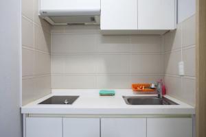a kitchen with a sink and a counter top at Poem House in Jeju