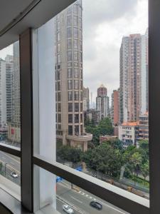 a view of a city skyline from a window at Echarm Hotel - Beijing Road Pedestrian Street Sky Pier in Guangzhou