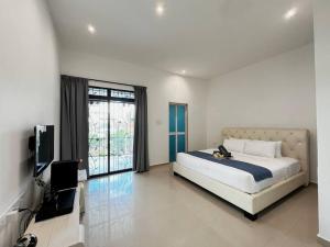 a bedroom with a bed and a flat screen tv at Kim Teng Park, by Antlerzone in Johor Bahru