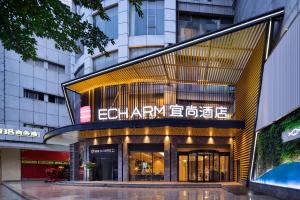 a building with a sign on the front of it at Echarm International Hotel Guangzhou Beijing Road Pedestrian Street Tianzi Wharf in Guangzhou