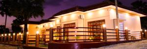 a building with a fence in front of it at night at Palm Path Resort in Jaffna