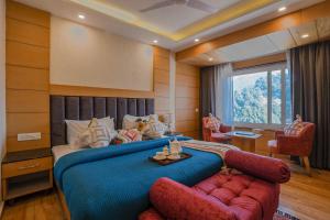 a bedroom with a large bed and a couch at Super Hotel by Perfectstayz Mall Road in Mussoorie