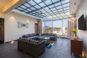 a living room with couches and a glass ceiling at Hotel Blue Chip By Downtown - Near Udaipur Airport in Dabok