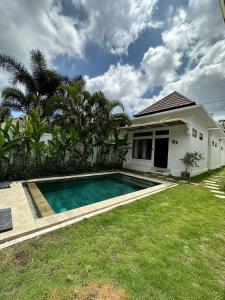 a house with a swimming pool in the yard at Susurro Residential in Kuta Lombok