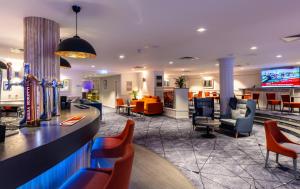 a hotel lobby with chairs and a bar at Copthorne Aberdeen Hotel in Aberdeen