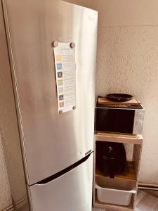 a refrigerator with a microwave on top of it at Artsy Room for 2 in Prenzlauer Berg - Ideal Stay in Shared Flat in Berlin