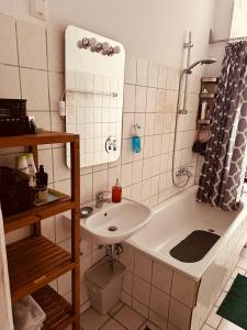 a bathroom with a sink and a bath tub at Artsy Room for 2 in Prenzlauer Berg - Ideal Stay in Shared Flat in Berlin