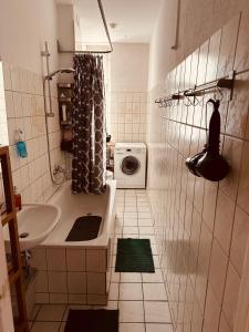 a bathroom with a sink and a washing machine at Artsy Room for 2 in Prenzlauer Berg - Ideal Stay in Shared Flat in Berlin