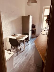 a small kitchen with a table and a refrigerator at Artsy Room for 2 in Prenzlauer Berg - Ideal Stay in Shared Flat in Berlin