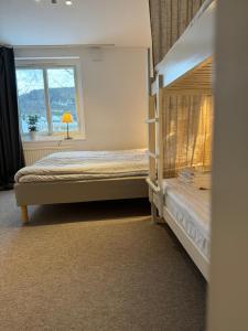 a bedroom with two bunk beds and a window at STF Sälen Torgåsgården in Lima