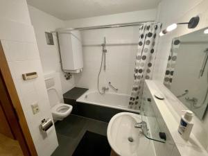 a bathroom with a toilet and a tub and a sink at Relax Holidays in Rheinheim +17 photos