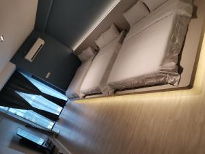 a bedroom with two beds in a room at HOTEL SENTOSA KOTA BHARU Kelantan in Kota Bharu