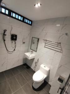 a bathroom with a toilet and a sink at HOTEL SENTOSA KOTA BHARU Kelantan in Kota Bharu