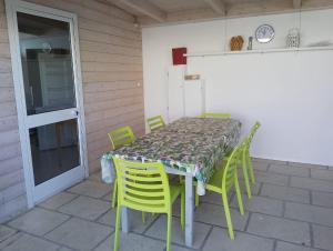 a table and chairs sitting on a patio at Casa Alba by My Home Apulia in Torre Lapillo