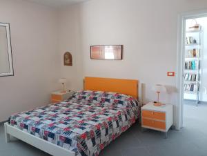 a bedroom with a bed and two night stands at Casa Alba by My Home Apulia in Torre Lapillo +86 photos